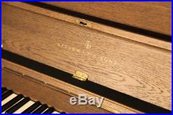 A 1985, Steinway Model K upright piano with a polished, oak case
