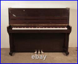 A 2001, Pearl River upright piano with a mahogany case. 12 month warranty