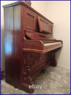 Antique mahoganypiano upright, beautiful wood carving, center section pulls out