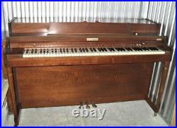 Baldwin Piano with open storage bench and 1970's Seth Thomas metronome