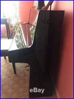 Black lacquer samick up right piano with matching bench slightly used 1 owner