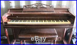 Brown full size upright console piano